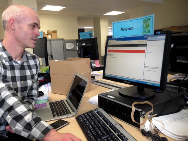 Internal research for MoJ, man sitting at a desk with a desktop and laptop 