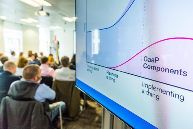 A photo with a presentation screen showing the phrase 'GaaP components'