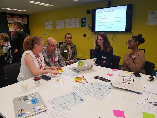 Photo of aphasia advisors Sian and Colin, GDS User researcher doing a usability task together